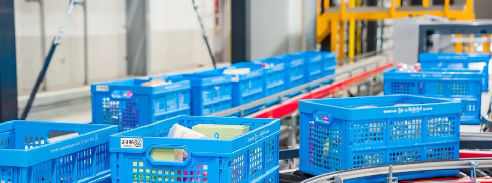 Crates on a conveyor in an automated warehouse